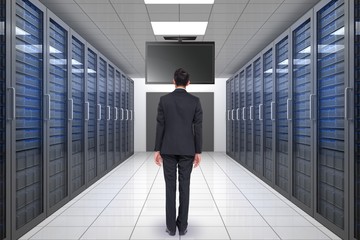 Fototapeta premium Composite image of businessman turning his back to camera