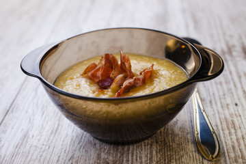 pea puree with slices of fried bacon