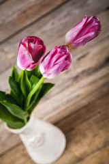 Vase of natural tulips. flowers on a wooden background