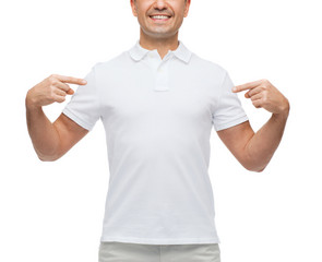 smiling man in t-shirt pointing fingers on himself