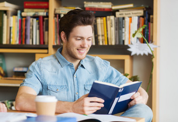 happy student reading book and drinking coffee