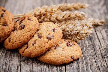 Cookies with wheat on a wooden table.