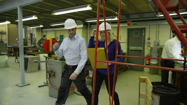 Staff members in a busy warehouse, each carrying out their own roles