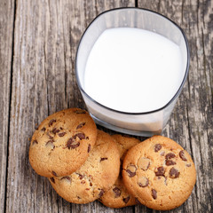 Cookies with milk on a wooden table.