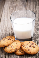 Cookies with milk on a wooden table.