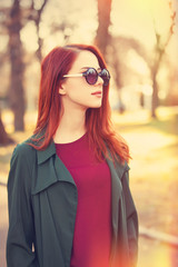 Style redhead girl in sunglasses