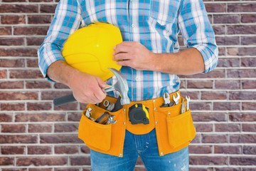 Manual worker wearing tool belt