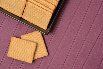 Cookies arranged in a black ceramic vase with purple background