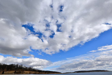 Storm clouds landscape over frozen lake.