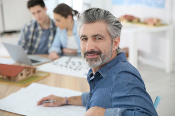 Portrait of smiling teacher in architecture