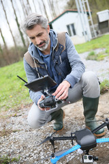 Man operating a drone with remote control