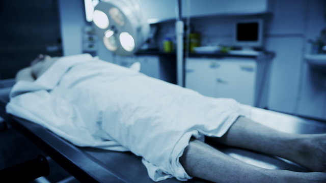 Dead male body laid out on an autopsy table