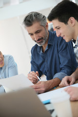 Fototapeta premium Students with trainer working on project