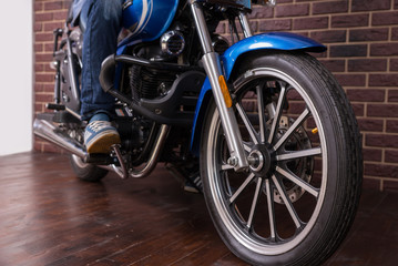 Fototapeta na wymiar Wheel of a Sports Motorbike on the Wooden Floor