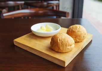 Bread with butter on a rustic cutting board