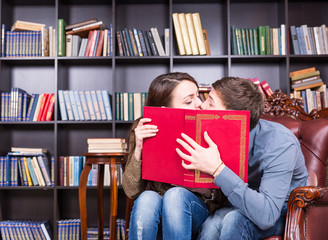 Romantic young couple sneaking a kiss
