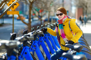 Fototapeta na wymiar Young beautiful woman ready to rent a city bike