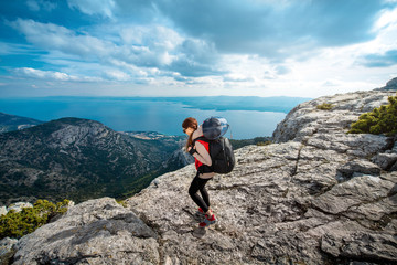 Young mountain climber on the top of island