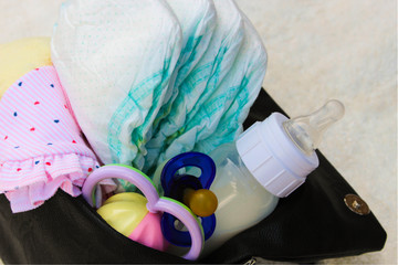 Women's handbag with items to care for the child