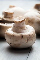 White button mushrooms on a wooden blue table