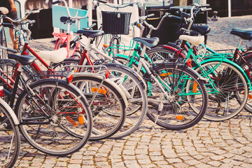 Fototapeta na wymiar Row Of Parked Bicycles. Bicycle Parking In Big City