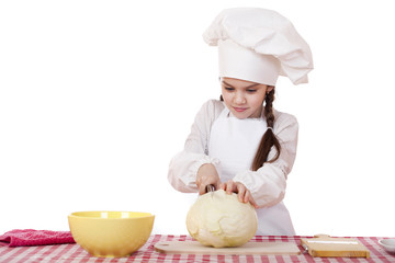 Portrait of a little girl in a white apron and chefs hat shred c