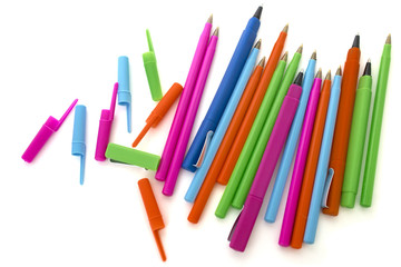 colored pens on a white background