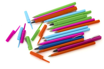 colored pens on a white background