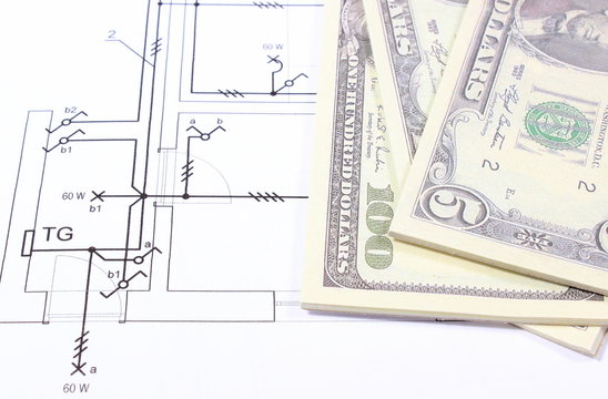 Heap of banknotes on construction drawing of house
