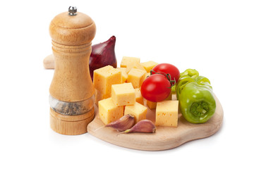 Mill , cheese and vegetables on wooden board