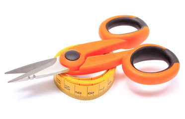 Scissors with tape measure on white background