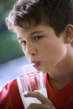 Young, twelve years old, sipping a lemonade
