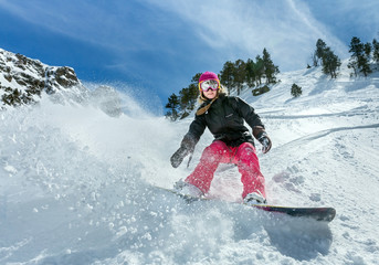 Fototapeta Woman snowboarder in motion in mountains obraz