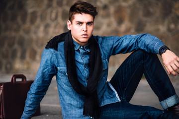 Young Handsome Businessman dressed in jeans sitting on the floor - 80541949