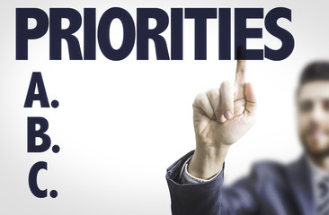 Business man pointing the text: Priorities