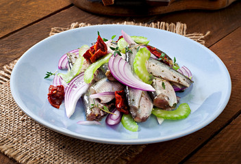 Herring salad with sun-dried tomatoes, celery and red onion