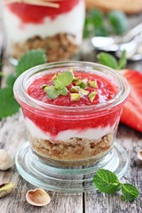 Dessert of oat cookies , yogurt, strawberries and pistachios