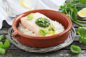 Steamed salmon with pesto and rice garnish.Selective focus.