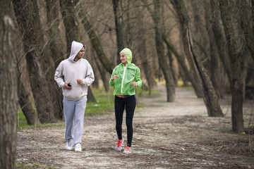 Obraz premium Two young athletes jogging in nature