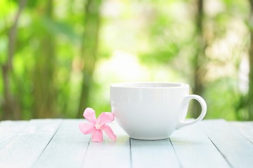 White coffee cup and frangipani flower