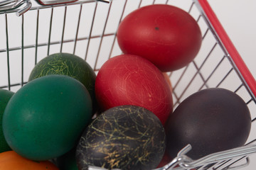 colorful painted Easter eggs in the basket for shopping
