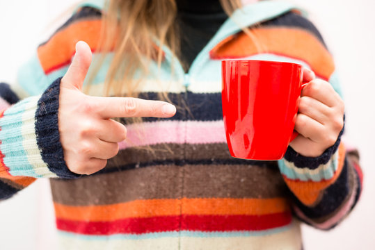hands holding a cup of tea (coffee)