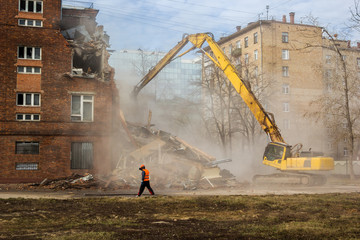 excavator demolishes old school building