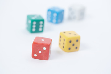 colored playing dice in a chaotic manner on a white background