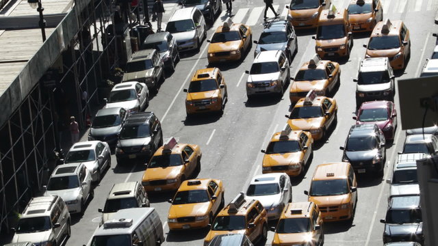 Time lapse of traffic congestion and pedestrians on a busy New York street