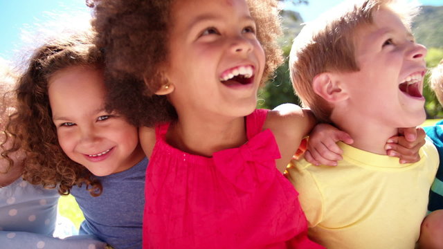 Mixed racial group of friendly children laughing together