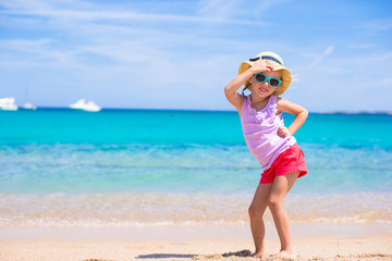 Adorable little girl have fun at tropical beach during vacation