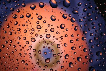 Water drops on plastic surface with refracted image