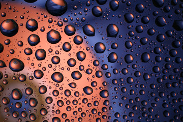 Water drops on plastic surface with refracted image