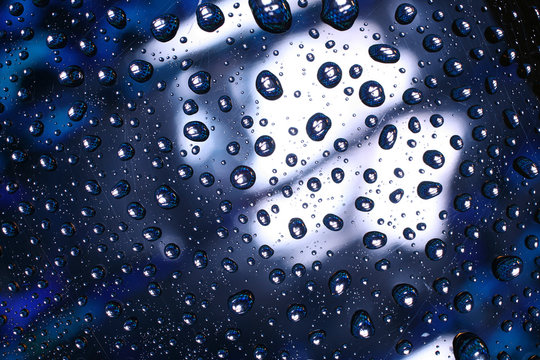 Water drops on plastic surface with refracted image